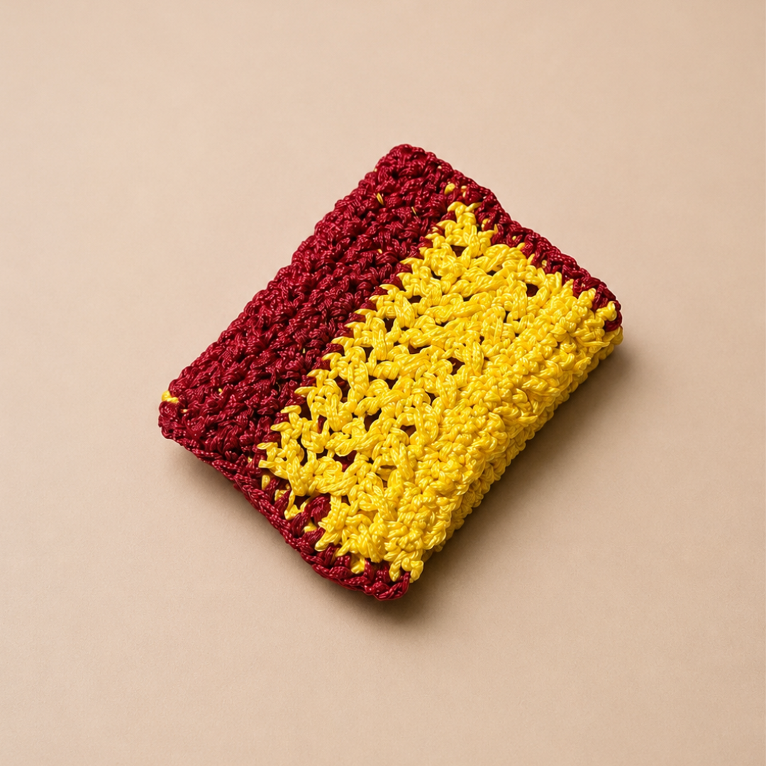 Crocheted pouch with red and yellow pattern on a beige background